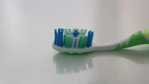 Hand spreading toothpaste on a toothbrush. Stock Footage 134077081
