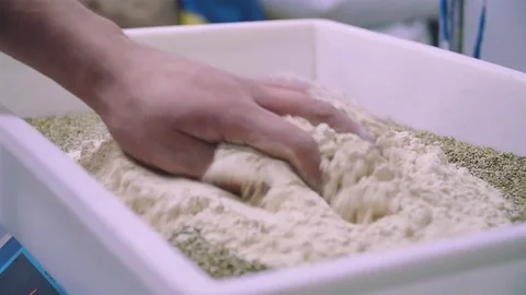 Hand spreads evenly flower on the corn before prepare bread 库存影片 73366434
