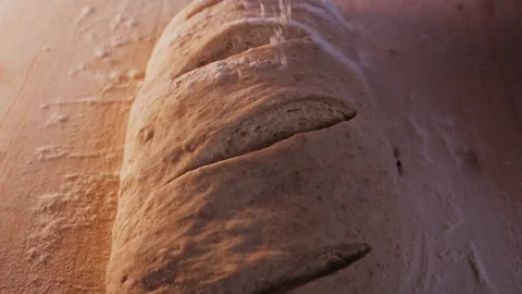 Hand sprinkle the bread dough with flour, closeup 動画素材 151405438