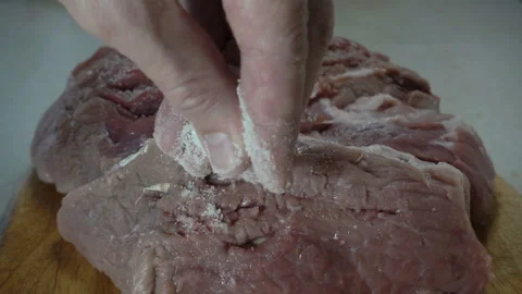 Hand sprinkle with salt in slow motion meat. Stock Footage 133061988