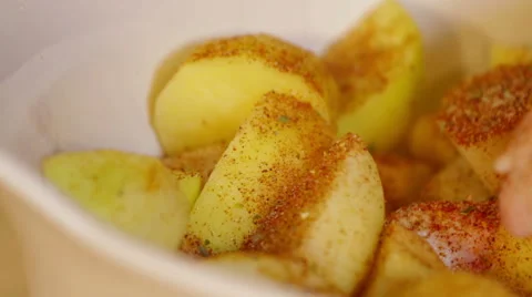 Hand sprinkle spices on potatoes. Close up Stock Footage 57948190