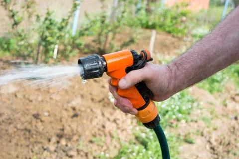 Hand with sprinkler Stock Photos