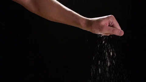 Hand Sprinkling Flour On Black Background Stock Footage 82149797