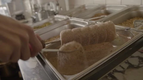 Hand Sprinkling Sugar Over Baked Pastry Roll in Commercial Kitchen, Sydney Stock Footage 345659877