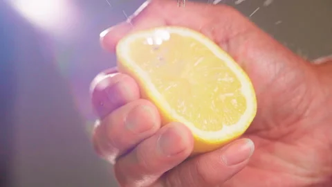 Hand squeeze half lemon splash close up slow motion Stock-Footage 158432028