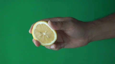 Hand squeeze lemon slow motion on Green screen Stock Footage 113464851
