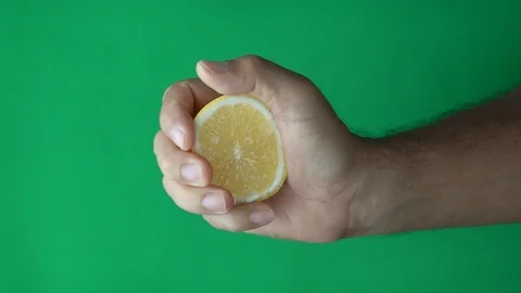 Hand squeeze lemon slow motion on Green screen Stock-Footage 113464951