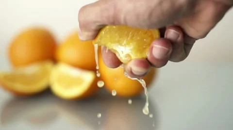Hand squeeze orange, slow motion shot at 480fps HD Stock Footage 12368062