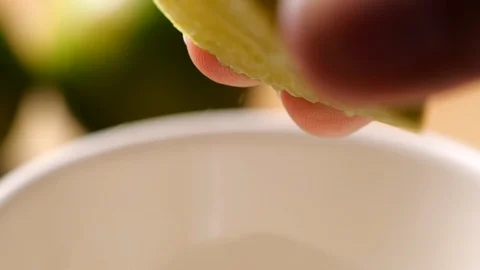 Hand squeezed lime in slow motion Stock Footage 130088926