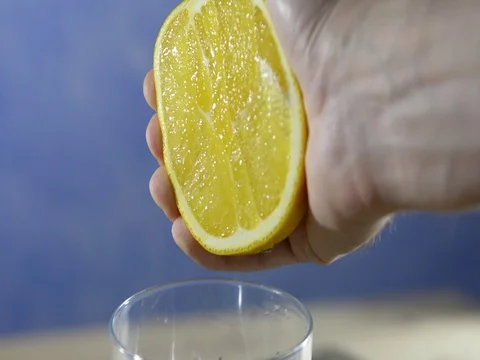 Hand squeezes orange fresh. Slow close up Stock Footage 121665332