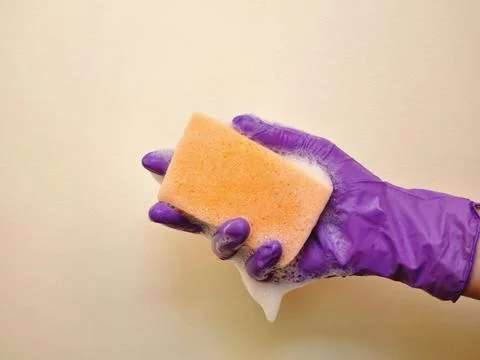 Hand squeezes a sponge with foam Stock Photos