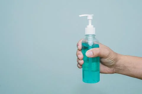 The hand is squeezing alcohol and there is space. Stock Photos