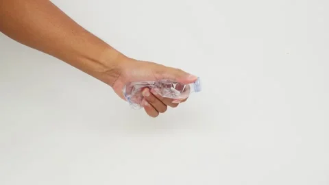 Hand Squeezing and Crushing a Plastic Bottle Stock Footage 327851672