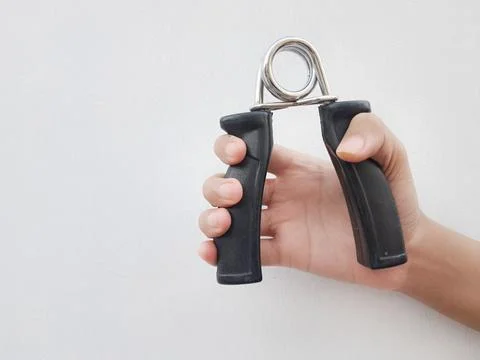 Hand squeezing a black hand gripper Stock Photos