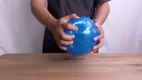 Hand squeezing blue Rubber ball Stock-Footage 345586283