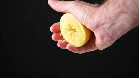 Hand Squeezing a Fresh Lemon Stock Footage 309448357