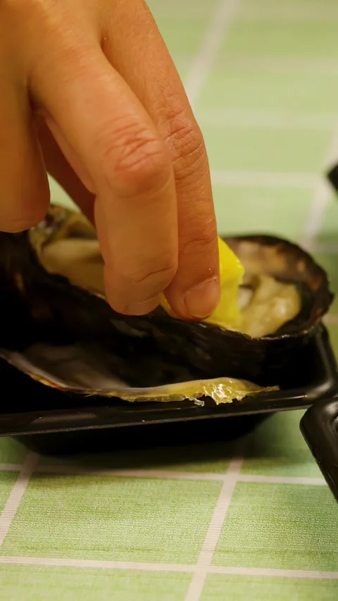 Hand Squeezing Fresh Lemon Juice onto Raw Oyster in Tokyo Stock Footage 343600072