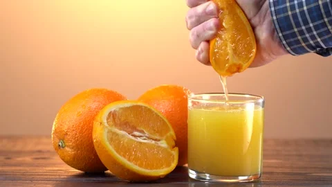 Hand Squeezing Fresh Orange Juice, healthy food concept,slow motion Stock Footage 153323074