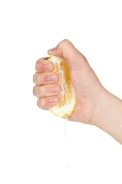 Hand squeezing lemon Stock Photos