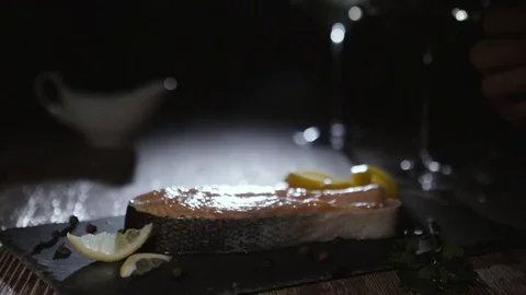 Hand squeezing lemon on a salmon steak Stock Footage 72714705