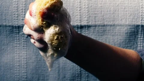 Hand squeezing natural sponge water soapy suds water Stock Footage 271232294