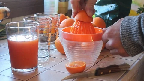 Hand squeezing orange juice Stock Footage 105070420