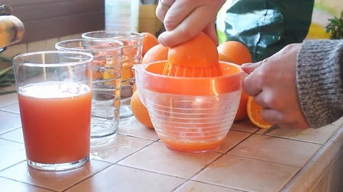 Hand squeezing orange juice Stock Footage 105070560
