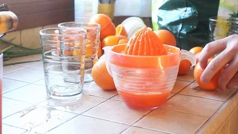 Hand squeezing orange juice Stock Footage 105070593