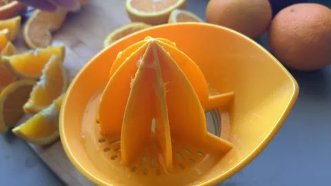 Hand Squeezing Orange Juice Stock Footage 134356640