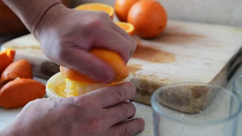 Hand squeezing orange juice. Stock Footage 178365104