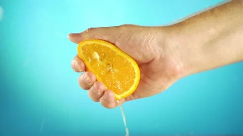 Hand squeezing out fresh orange Video stock 135836829
