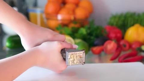 Hand Squeezing Out Minced, Crushed, Garlic Using A Small Garlic Pressing Tool. Stock Footage 302821719