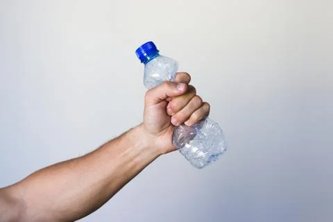 Hand squeezing Plastic Bottle 库存照片