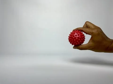 Hand Squeezing Red Spiky Massage Ball for Rehabilitation Stock Photos