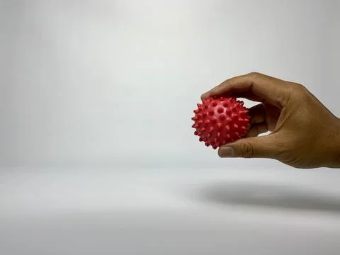 Hand Squeezing Red Spiky Massage Ball for Rehabilitation Stock Photos