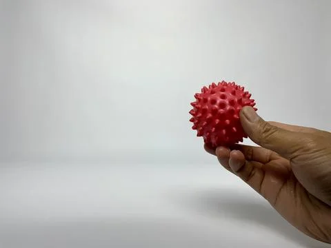 Hand Squeezing Red Spiky Massage Ball for Rehabilitation Stock Photos