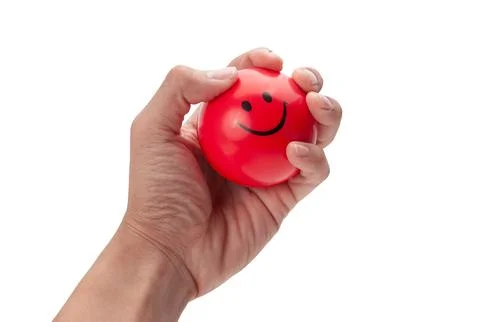 Hand squeezing a red stress ball isolated on white background with clipping.. Stock Photos