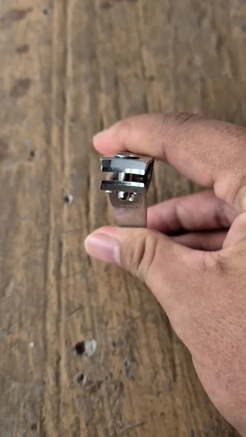 A hand squeezing a stainless steel nail clipper Stock Footage 337249885