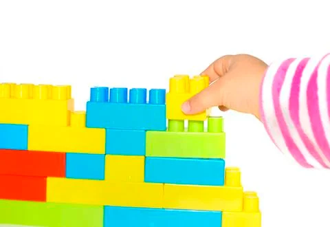 Hand stack up lego set as a wall on white background Stock Photos