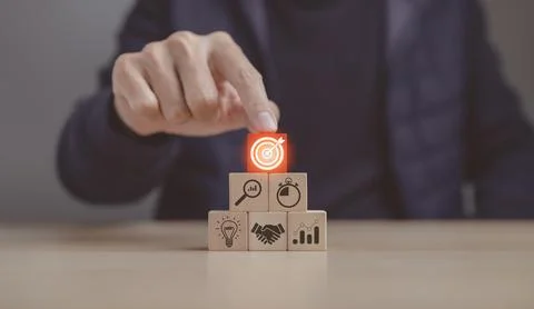 Hand stack woods block step on a table with icon business strategy. Stock Photos