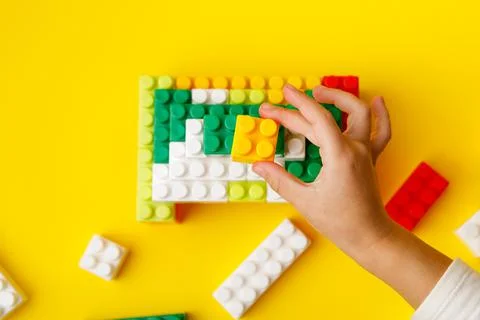 Hand stacking up the colorful plastic block. Foto stock
