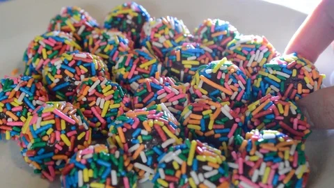 Hand stacking typical brazilian sweet candy at birthday parties, Brigadeiro Stock Footage 115371230