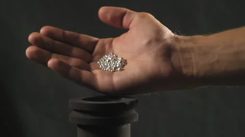 Hand staged throws silver pieces Stock Footage 196173708