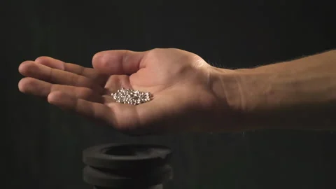 Hand staged throws silver pieces Stock Footage 196173832