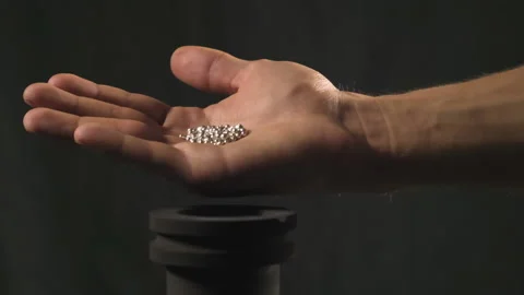 Hand staged throws silver pieces Video stock 196173900