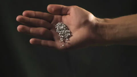 Hand staged throws silver pieces Stock Footage 196173981