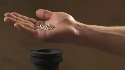 Hand staged throws silver pieces Stock Footage 196174014