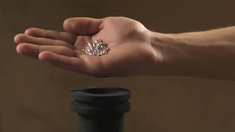 Hand staged throws silver pieces Stock Footage 196174064