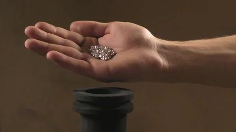 Hand staged throws silver pieces Stock Footage 196174092