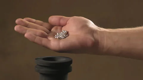 Hand staged throws silver pieces Stock Footage 196174354